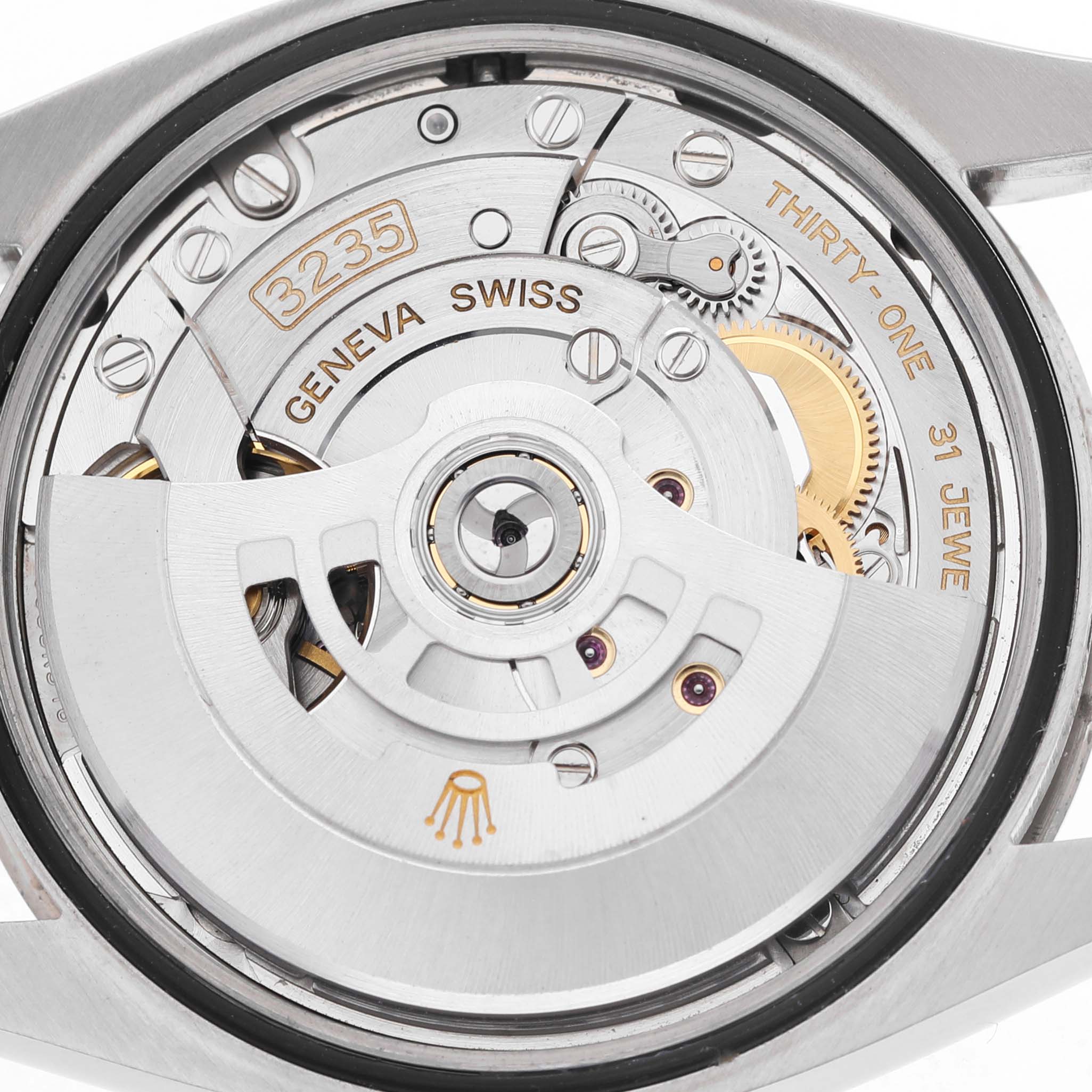 The image shows the Rolex Datejust 126234 Men's Stainless Steel Blue Dial's movement from a back angle, highlighting the rotor and intricate internal components.