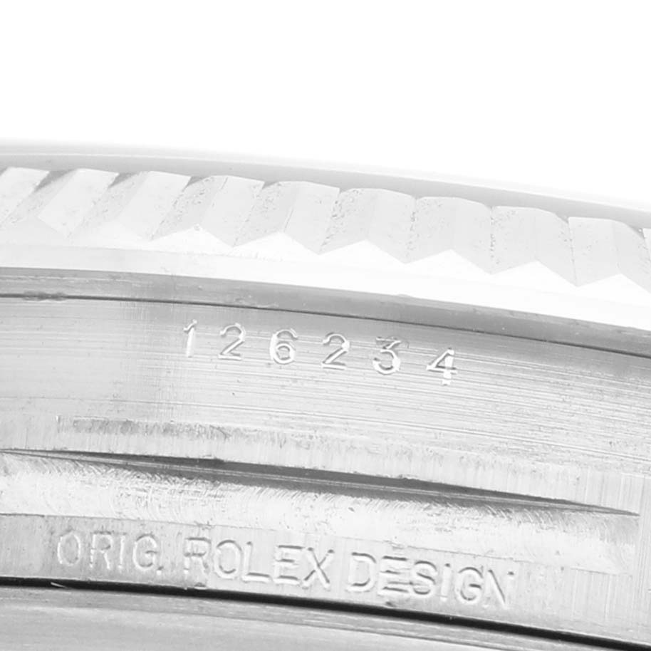 The image shows an angled close-up of the Rolex Datejust 126234 Men's Stainless Steel Blue Dial case, highlighting the engraved model number and fluted bezel.