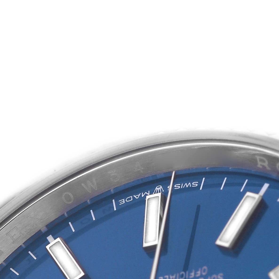 The image shows a close-up angle of the Rolex Datejust 126234 Men's Stainless Steel Blue Dial watch, focusing on the bezel, part of the dial, and indices.
