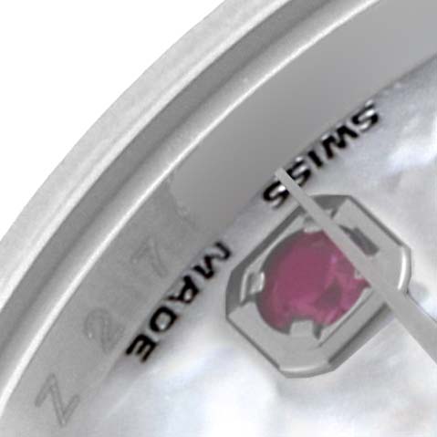 The image shows a close-up of a Rolex Datejust 179174 Women's Stainless Steel Mother of Pearl Dial 179174 Women's Stainless Steel Mother of Pearl Dial watch dial, highlighting a ruby, the text "SWISS MADE," and parts of the bezel.