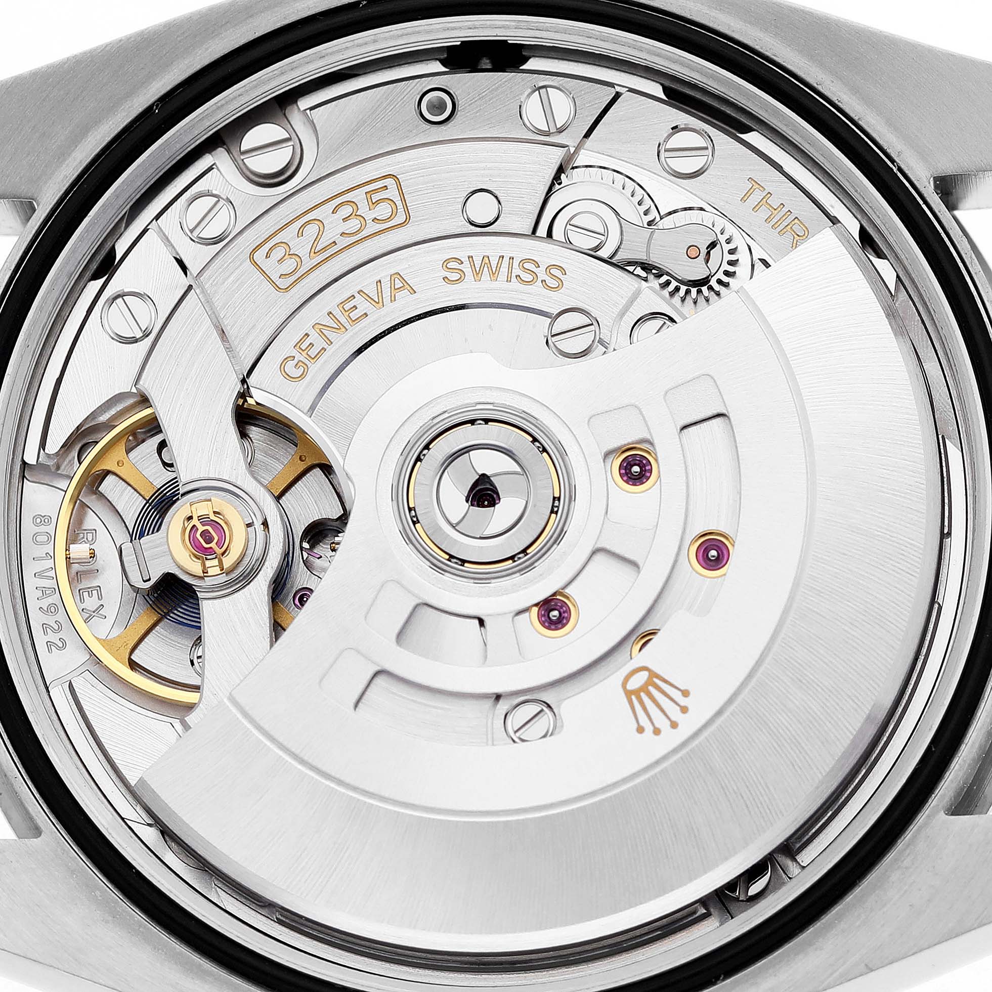 The image shows a close-up of the movement and inner workings of a Rolex Datejust 126234 Men's Stainless Steel Pink Dial watch, focusing on the rotor and gears.