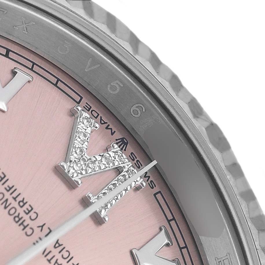 The image shows a close-up of the Rolex Datejust 126234 Men's Stainless Steel Pink Dial dial with diamond-studded Roman numerals and part of the fluted bezel.