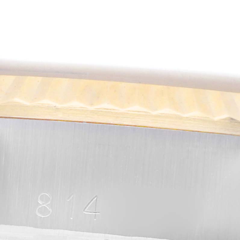 The image shows a close-up of the engraved side of the bezel on a Rolex Datejust 69173 Women's Steel and Gold (two tone) Champagne Dial 69173 Women's Steel and Gold (two tone) Champagne Dial watch.