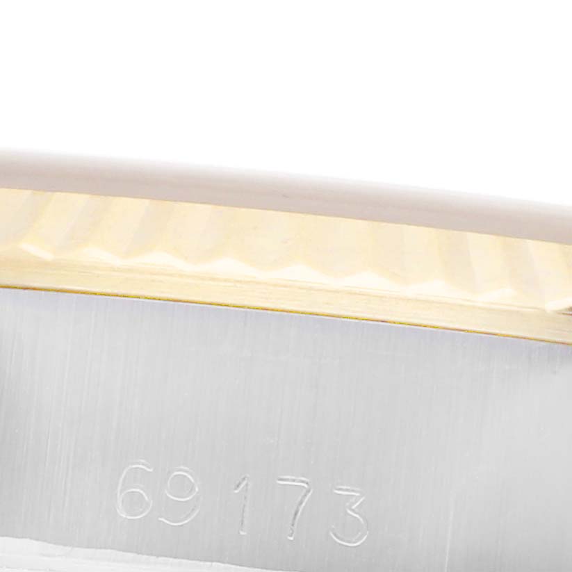 The image shows a close-up of the Rolex Datejust 69173 Women's Steel and Gold (two tone) Champagne Dial 69173 Women's Steel and Gold (two tone) Champagne Dial model's metal case, focusing on the reference number "69173" and part of the fluted bezel.