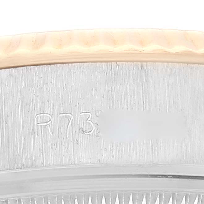 This image shows a close-up of the Rolex Datejust 69173 Women's Steel and Gold (two tone) Champagne Dial 69173 Women's Steel and Gold (two tone) Champagne Dial model's serial number etched on the case between the lugs.