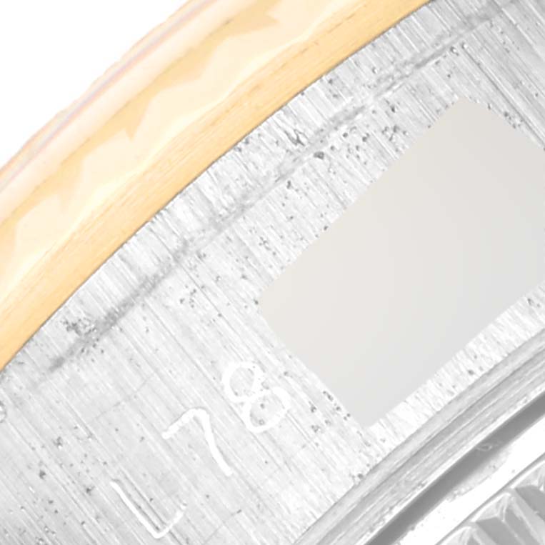 This close-up shows the bezel and rehaut of a Rolex Datejust 69173 Women's Steel and Gold (two tone) Champagne Dial 69173 Women's Steel and Gold (two tone) Champagne Dial watch, featuring some engraved markings.