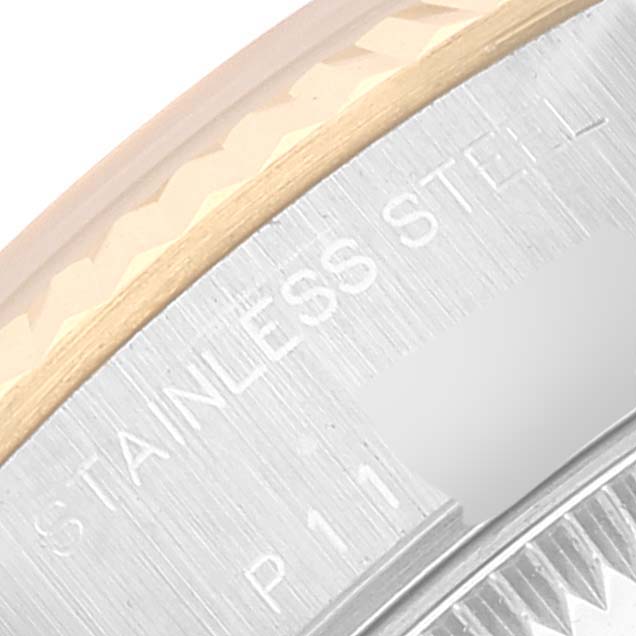 This close-up image shows the edge of the bezel and case back of a Rolex Datejust 79173 Women's Steel and Gold (two tone) Grey Dial 79173 Women's Steel and Gold (two tone) Grey Dial watch, revealing the "STAINLESS STEEL" engraving.
