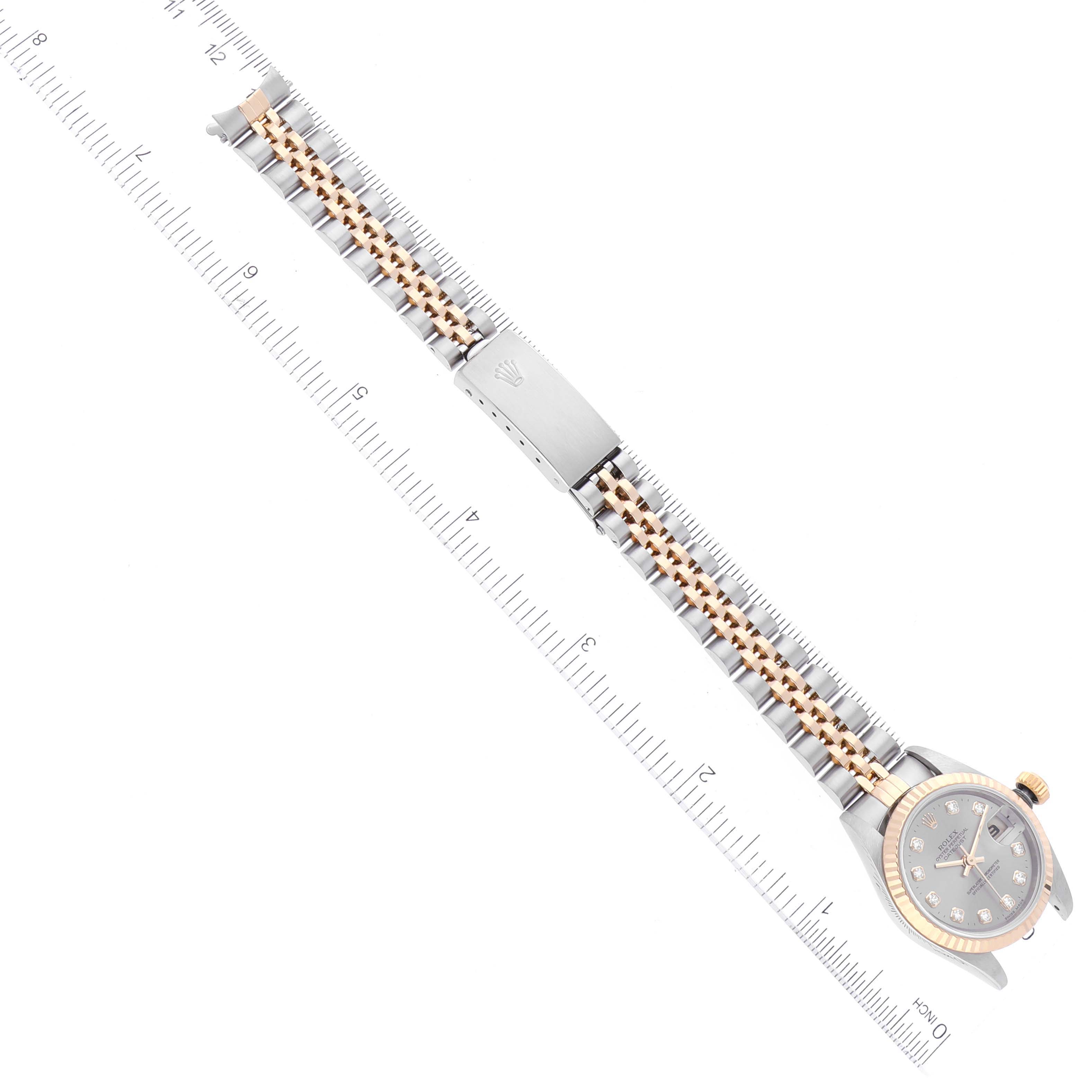 The image shows a Rolex Datejust 79173 Women's Steel and Gold (two tone) Grey Dial 79173 Women's Steel and Gold (two tone) Grey Dial watch viewed from the top, displaying its two-tone bracelet and clasp, laid next to a ruler for scale.
