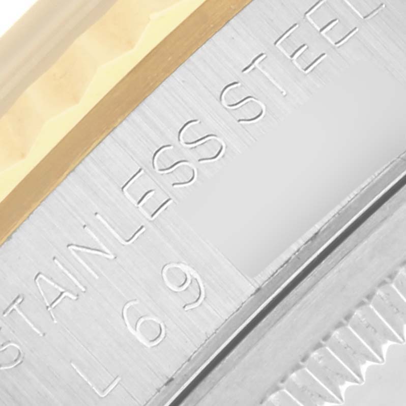 The image shows a close-up of the bezel and edge of the case of a Rolex Datejust 16233 Men's Steel and Gold (two tone) White Dial 16233 Men's Steel and Gold (two tone) White Dial, highlighting engraving details.