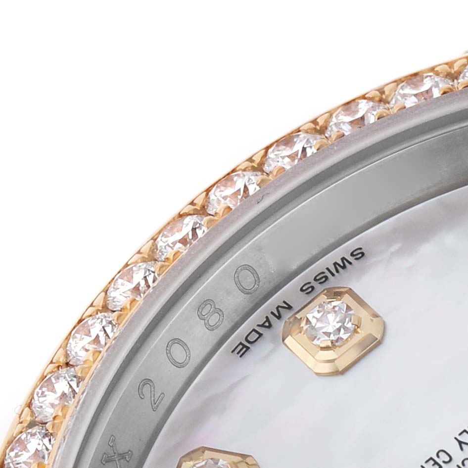 This close-up image shows the diamond-embedded bezel and part of the dial of a Rolex Datejust 116243 Men's Steel and Gold (two tone) Mother of Pearl Dial watch.