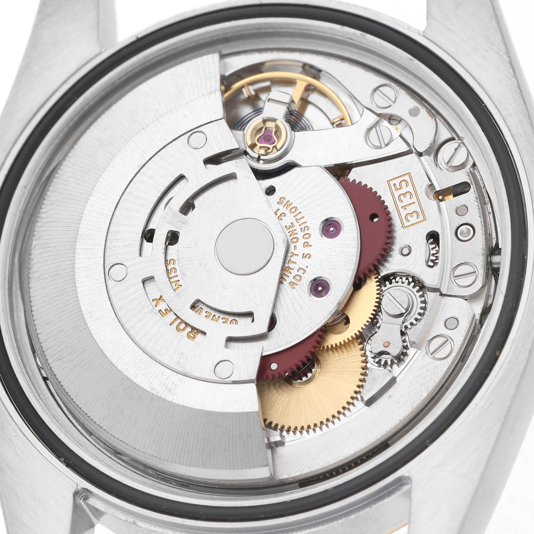The image shows the movement of a Rolex Datejust 116233 Men's Steel and Gold (two tone) Silver Dial watch from the back, highlighting gears and components.
