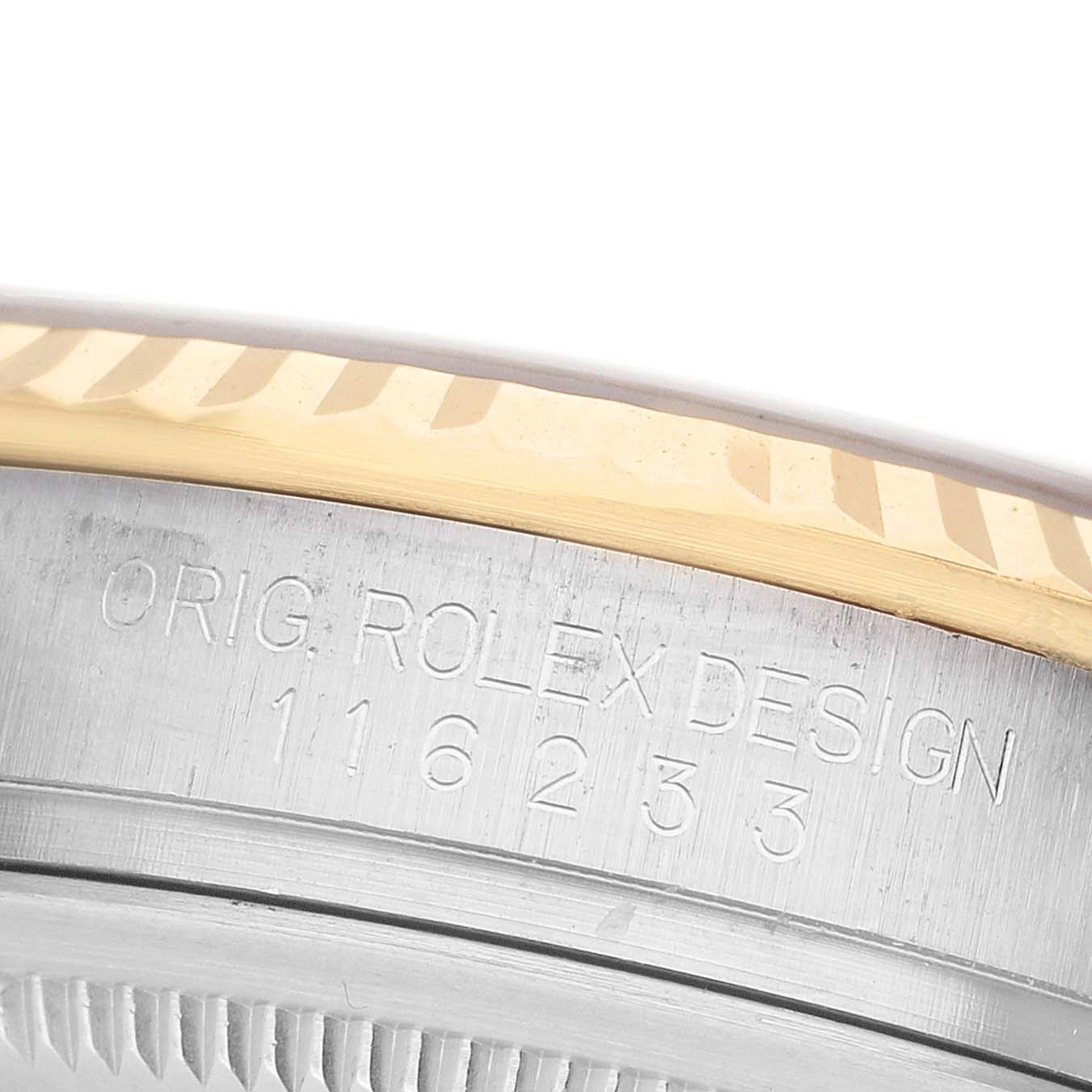 The image shows a close-up side view of a Rolex Datejust 116233 Men's Steel and Gold (two tone) Silver Dial watch, focusing on the bezel and engraved case details.