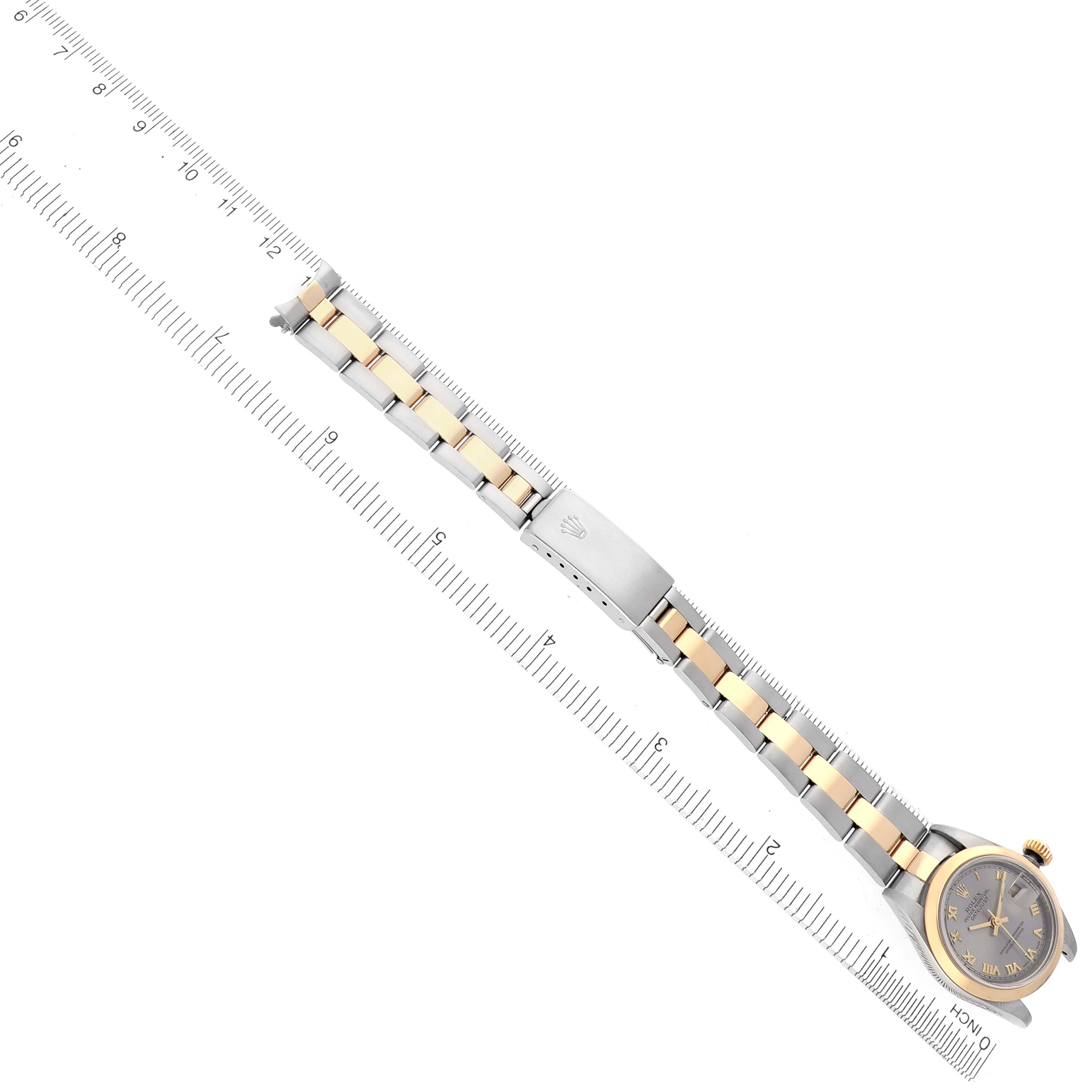 The image shows a Rolex Datejust 79163 Women's Steel and Gold (two tone) Grey Dial 79163 Women's Steel and Gold (two tone) Grey Dial watch laid flat, displaying the face, bracelet, and clasp with a ruler for scale.