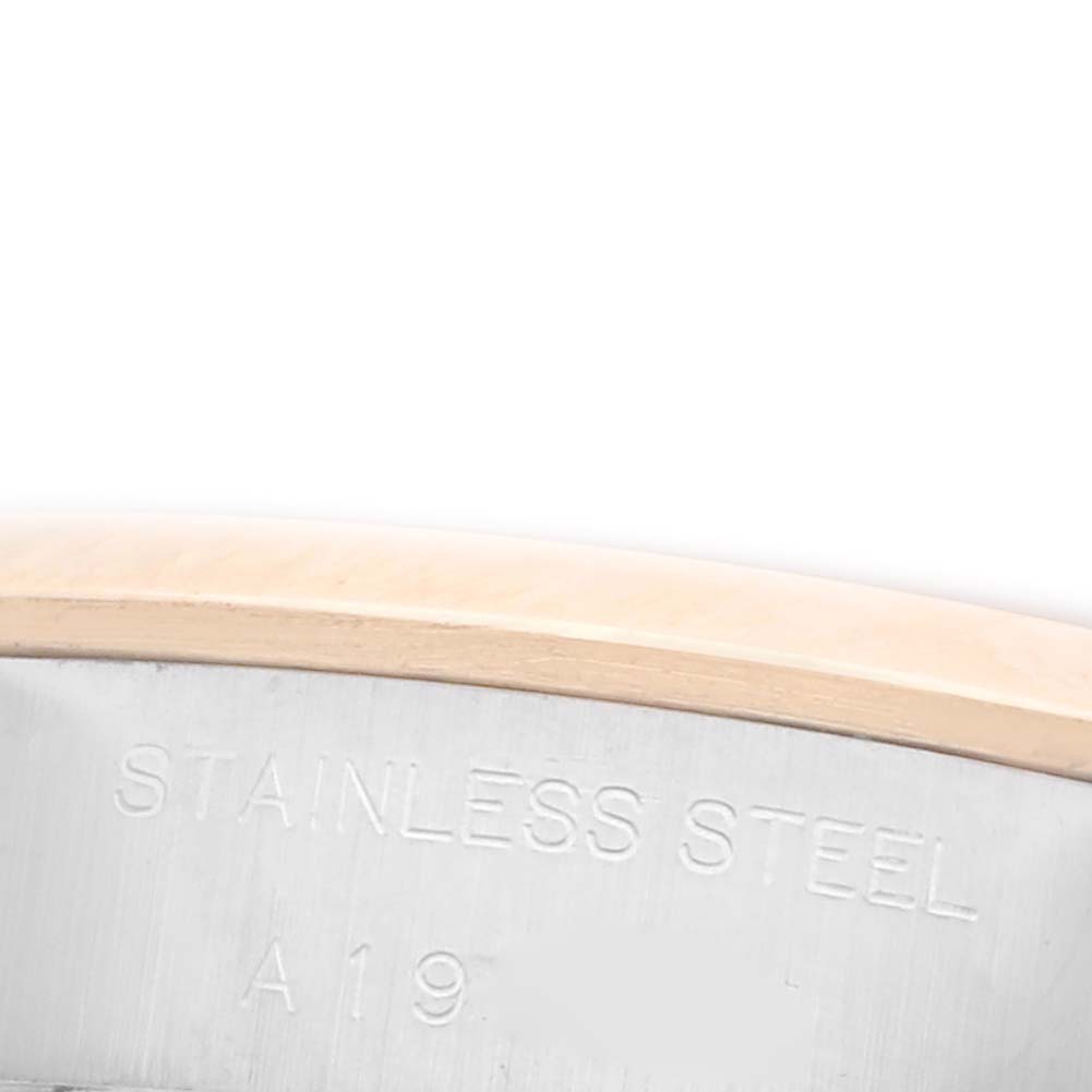 The image shows a close-up of the engraved stainless steel part of a Rolex Datejust 79163 Women's Steel and Gold (two tone) Grey Dial 79163 Women's Steel and Gold (two tone) Grey Dial.
