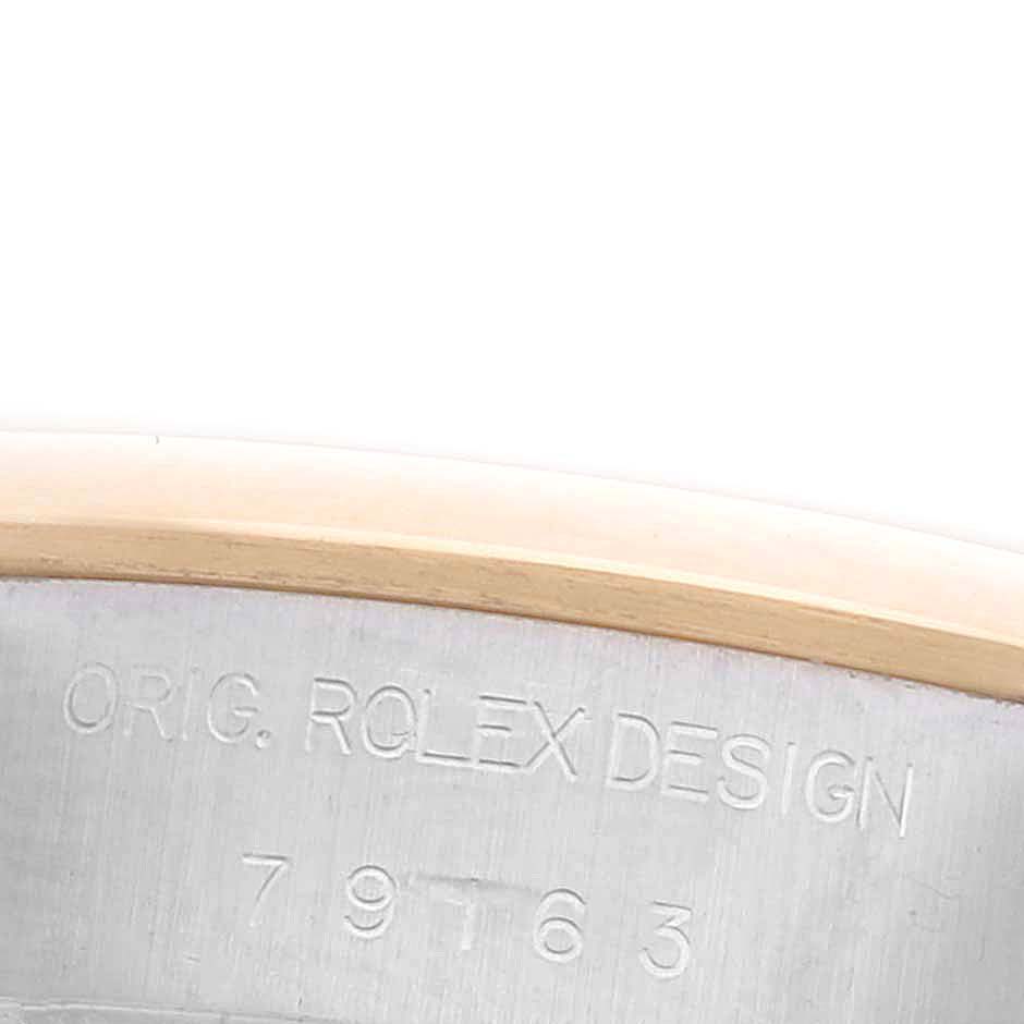 The image shows a close-up of the side of a Rolex Datejust 79163 Women's Steel and Gold (two tone) Grey Dial 79163 Women's Steel and Gold (two tone) Grey Dial watch case with engraved text.
