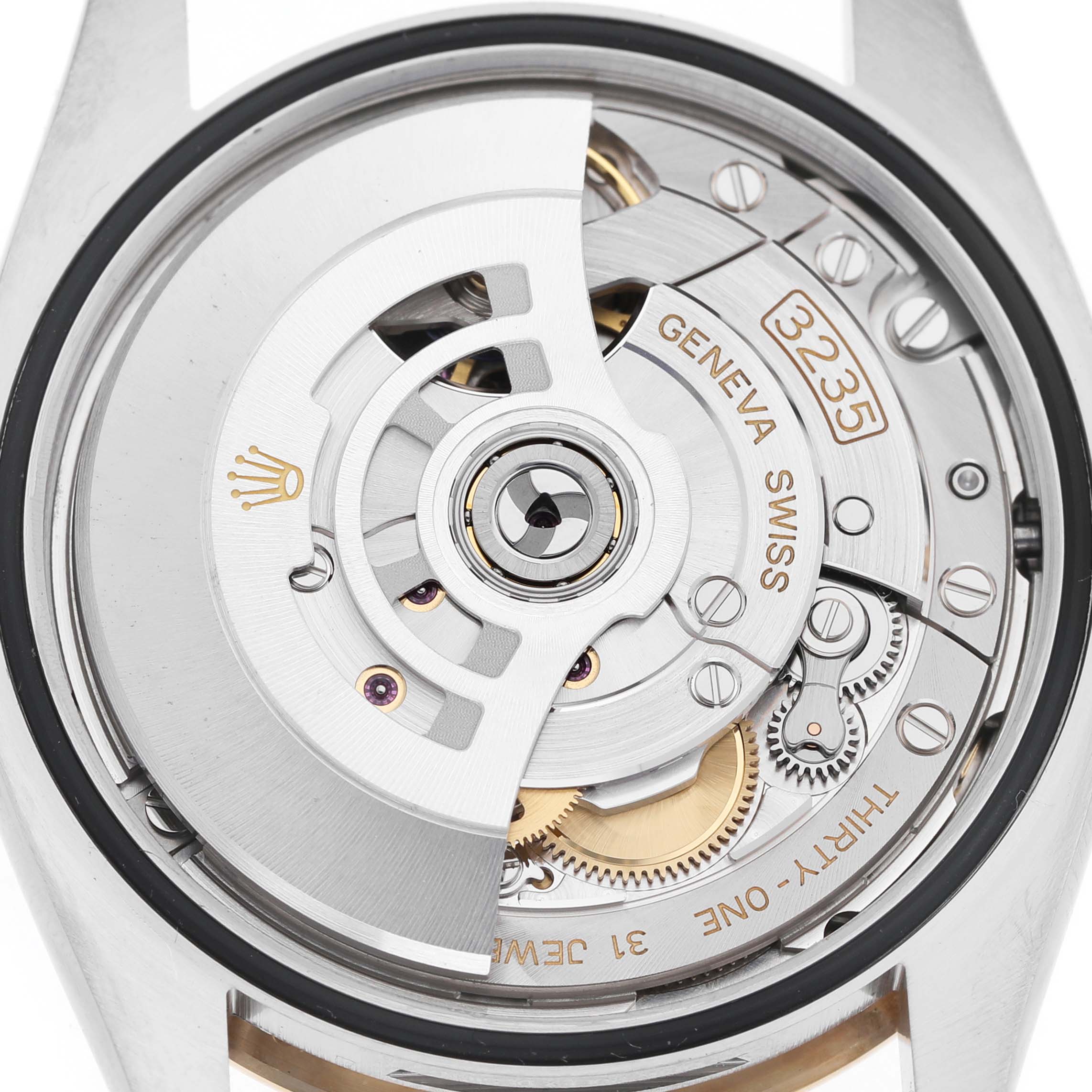 The image shows a close-up of the Rolex Datejust 126233 Men's Steel and Gold (two tone) White Dial movement from the back, highlighting the rotor and intricate internal components.