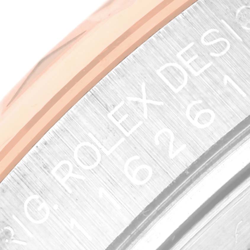 The image shows a close-up of the side engraving on a Rolex Turn-o-Graph 116261 Men
s Steel and Gold (two tone) Silver Dial 116261 Men
s Steel and Gold (two tone) Silver Dial watch, focusing on the bezel and caseback.