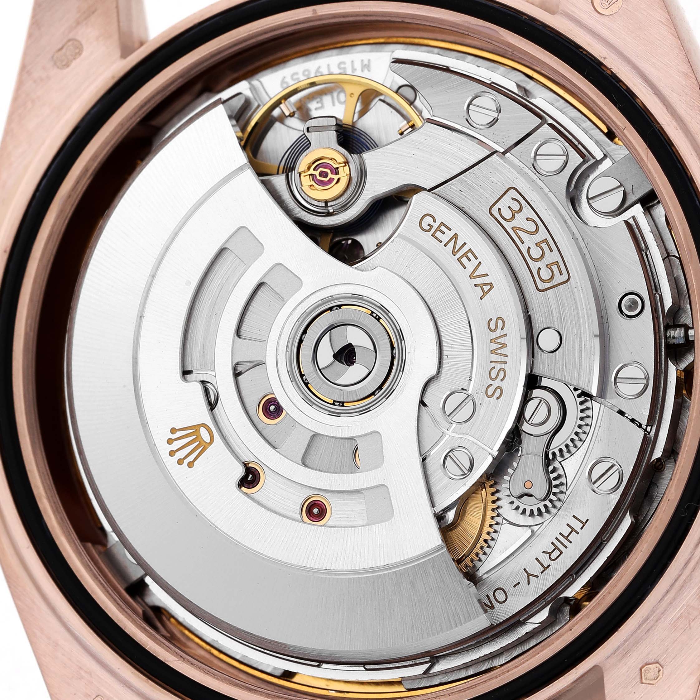 The image shows the movement of the Rolex President 228345 Men's Rose Gold Brown Dial model, highlighting the automatic rotor and intricate gears.