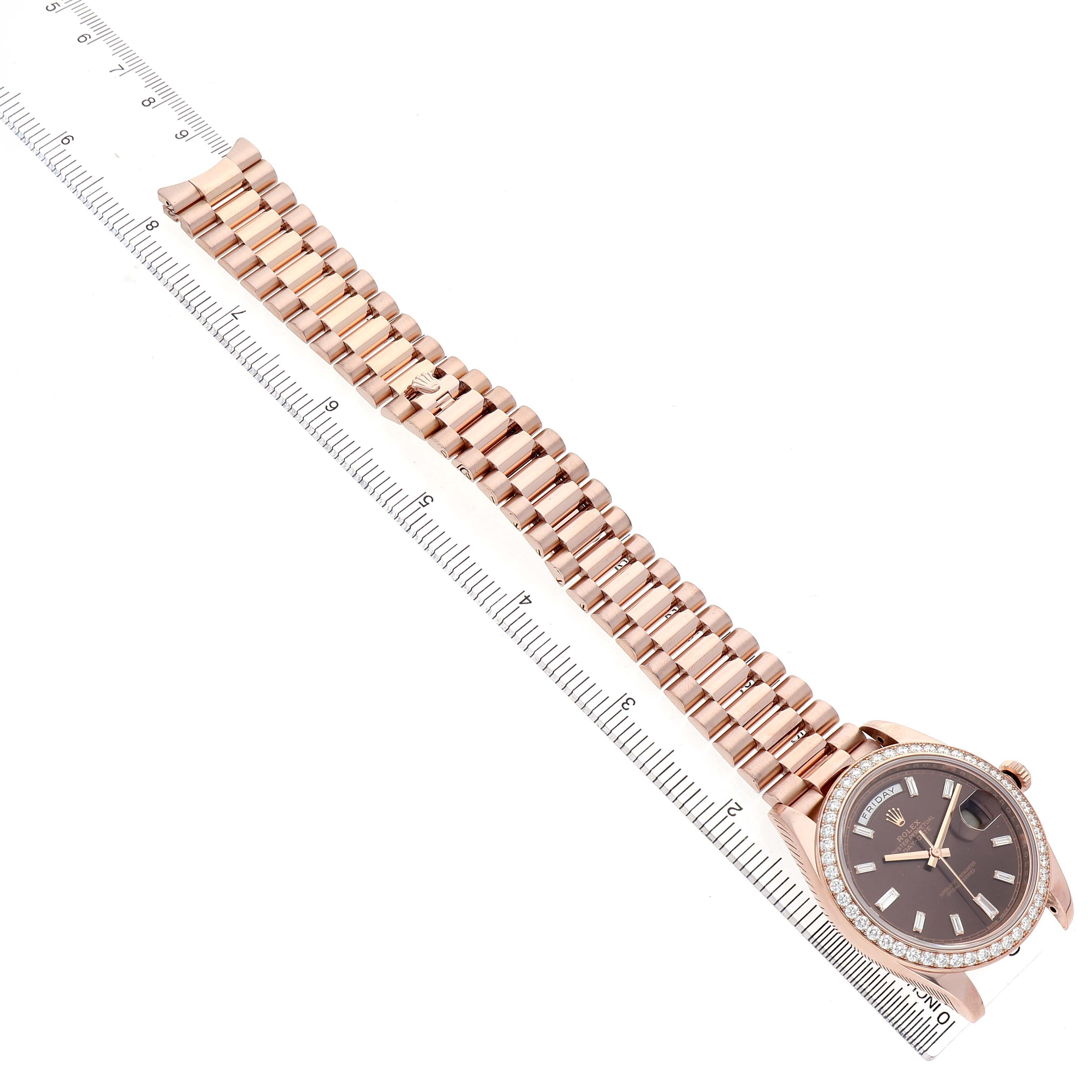 The Rolex President 228345 Men's Rose Gold Brown Dial watch is shown from a top-down angle, displaying the full bracelet and watch face.