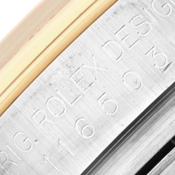 The image shows a close-up of the side of a Rolex Daytona 116503 Men's Steel and Gold (two tone) Mother of Pearl Dial 116503 Men's Steel and Gold (two tone) Mother of Pearl Dial watch, highlighting engraved text on the case.