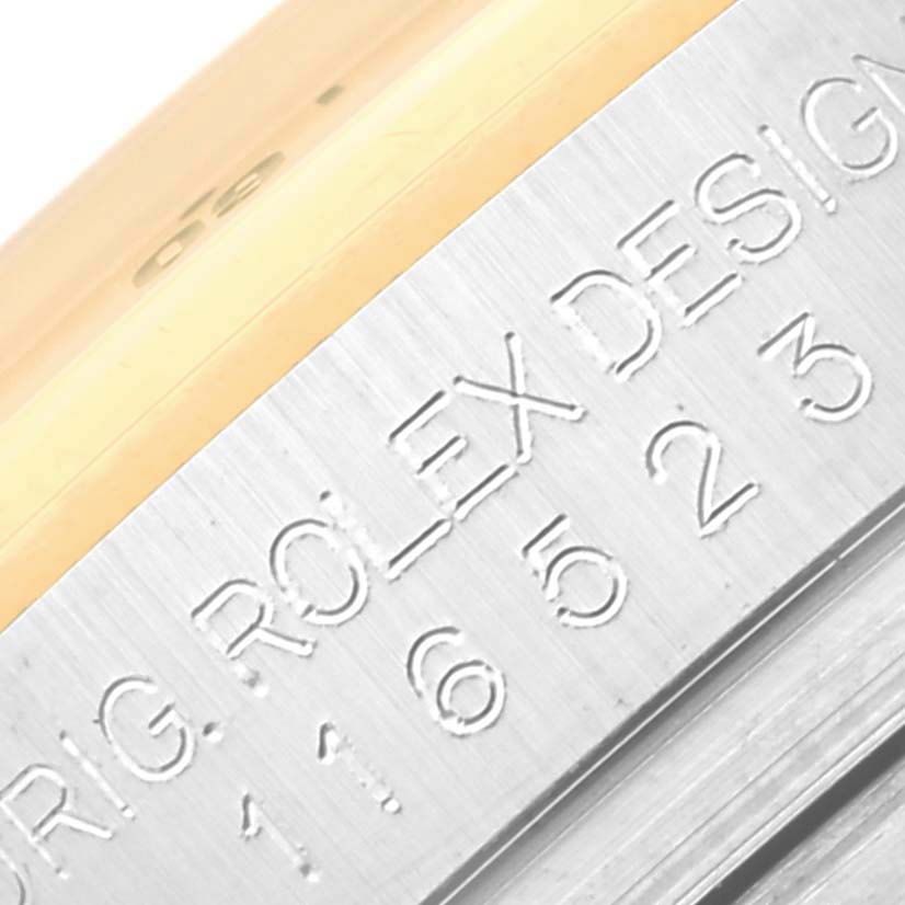 Close-up angle of a Rolex Daytona 116523NG Men's Steel and Gold (two tone) Mother of Pearl Dial 116523NG Men's Steel and Gold (two tone) Mother of Pearl Dial watch case showing "Rolex Design" and part of the serial number engraving.