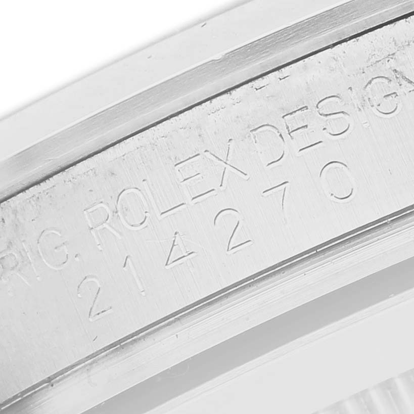 The image shows a close-up angle of the inner bezel with engraved text on a Rolex Explorer 214270 Men's Stainless Steel Black Dial watch.