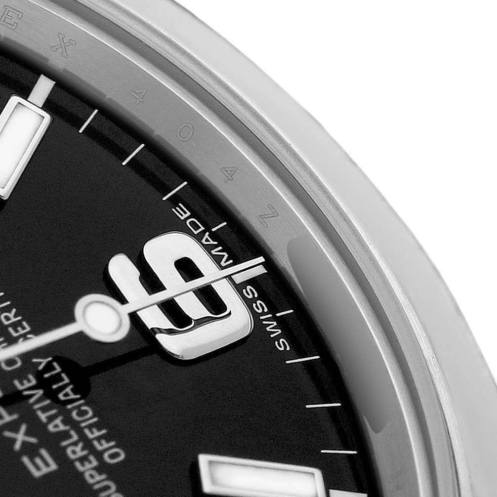 The image shows a close-up of the Rolex Explorer 214270 Men's Stainless Steel Black Dial's dial and bezel, focusing on the "9" hour marker and "SWISS MADE" text.