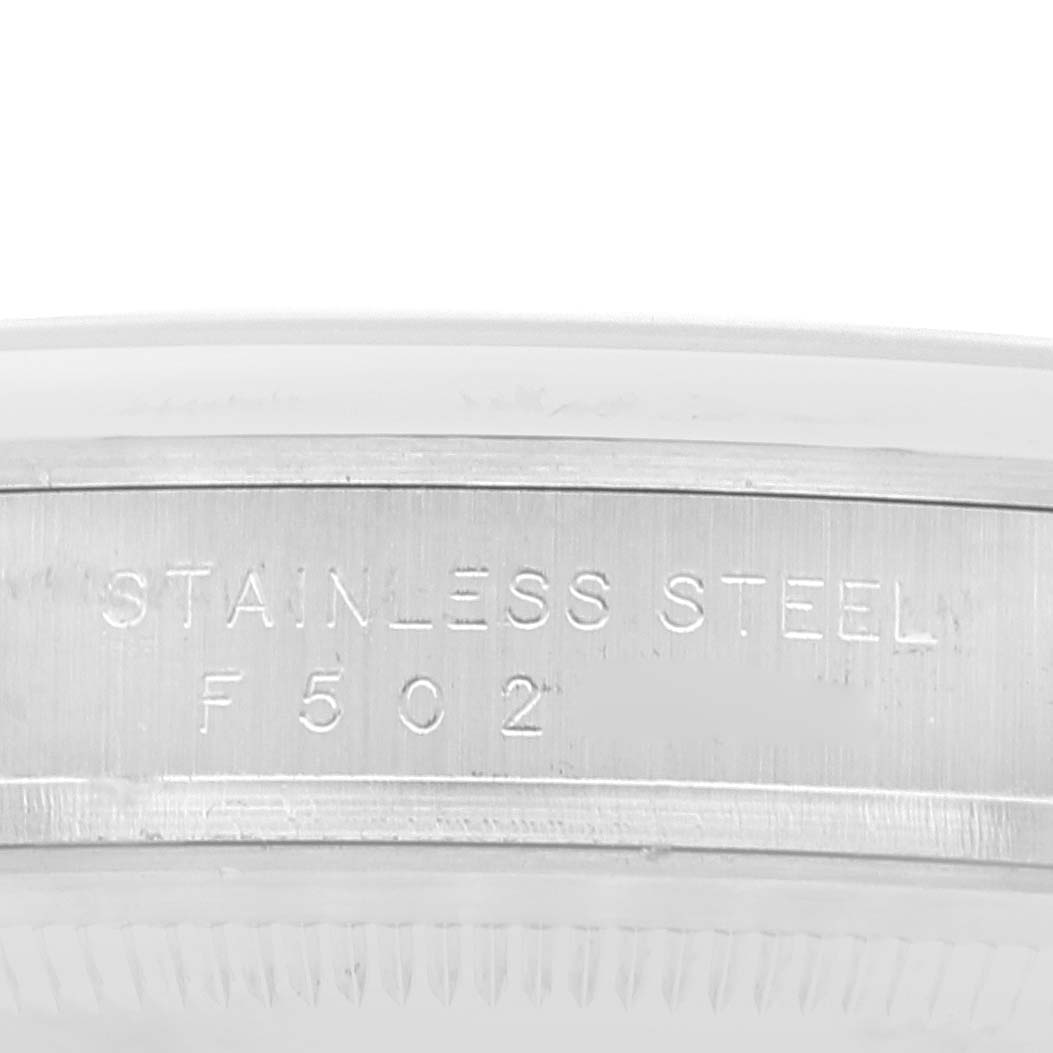 This image shows a close-up of the stainless steel case back rim of a Rolex Explorer 114270 Men
s Stainless Steel Black Dial 114270 Men
s Stainless Steel Black Dial watch.
