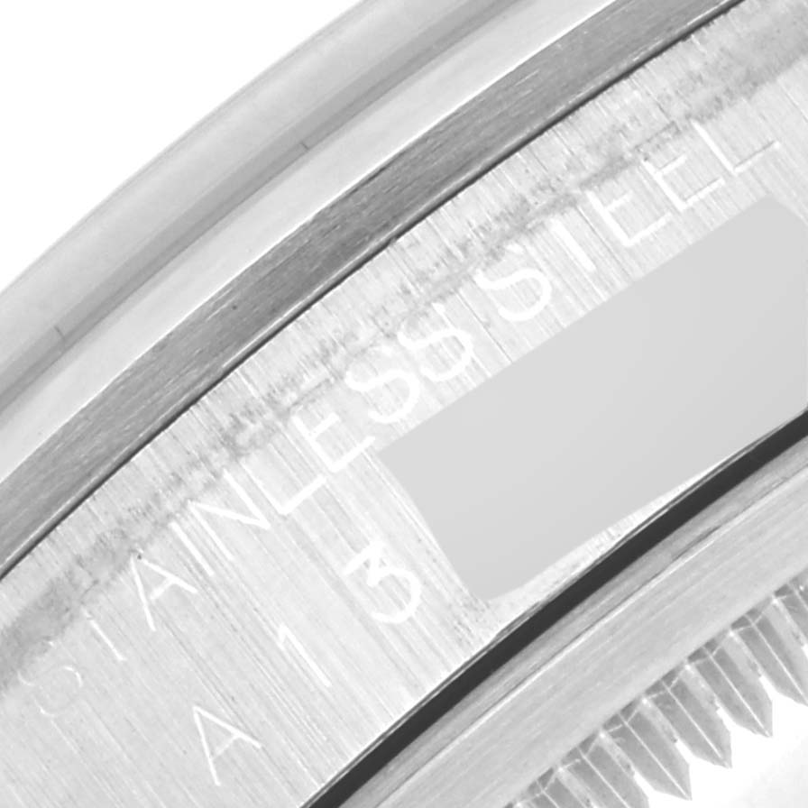This image shows a close-up view of the side of the Explorer model by Rolex, highlighting its stainless steel inscription and part of the bezel.