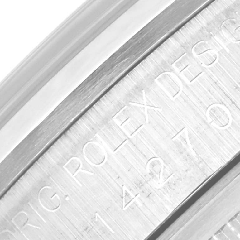 The image shows a close-up of the engraved side of the bezel of a Rolex Explorer 14270 Men
s Stainless Steel Black Dial 14270 Men
s Stainless Steel Black Dial watch.