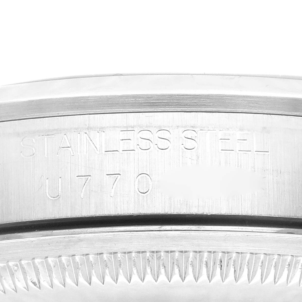 This is a close-up image showing the engraved serial number and "STAINLESS STEEL" inscription on the casing of a Rolex Explorer 14270 Men's Stainless Steel Black Dial 14270 Men's Stainless Steel Black Dial watch.
