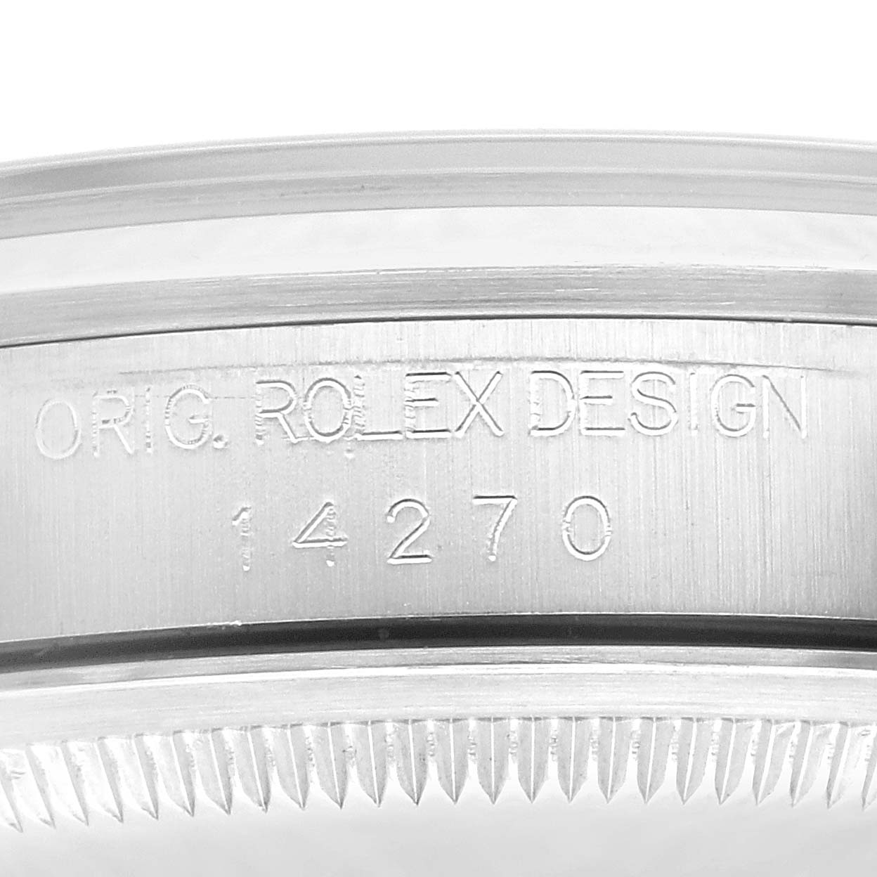 The image shows a close-up of the side of a Rolex Explorer 14270 Men's Stainless Steel Black Dial 14270 Men's Stainless Steel Black Dial watch case, with "ORIG. ROLEX DESIGN" and "14270" engraved.