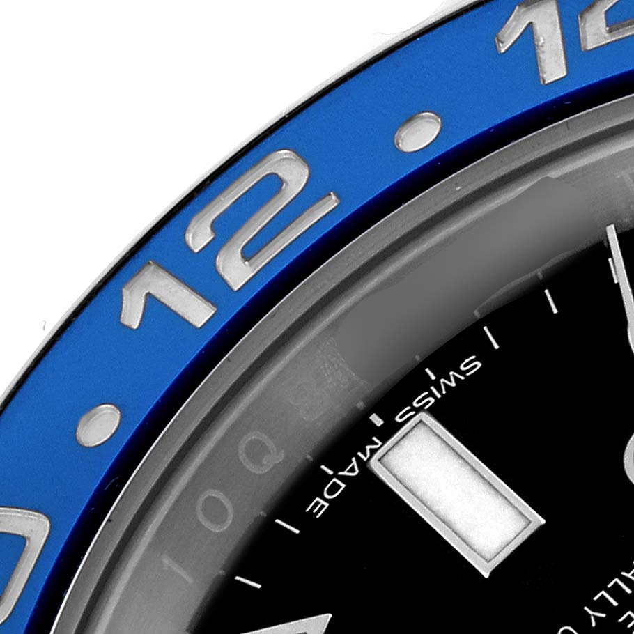 This close-up image shows the bezel and part of the dial of a Rolex GMT-Master 116710BLNR Men's Stainless Steel Black Dial 116710BLNR Men's Stainless Steel Black Dial watch.