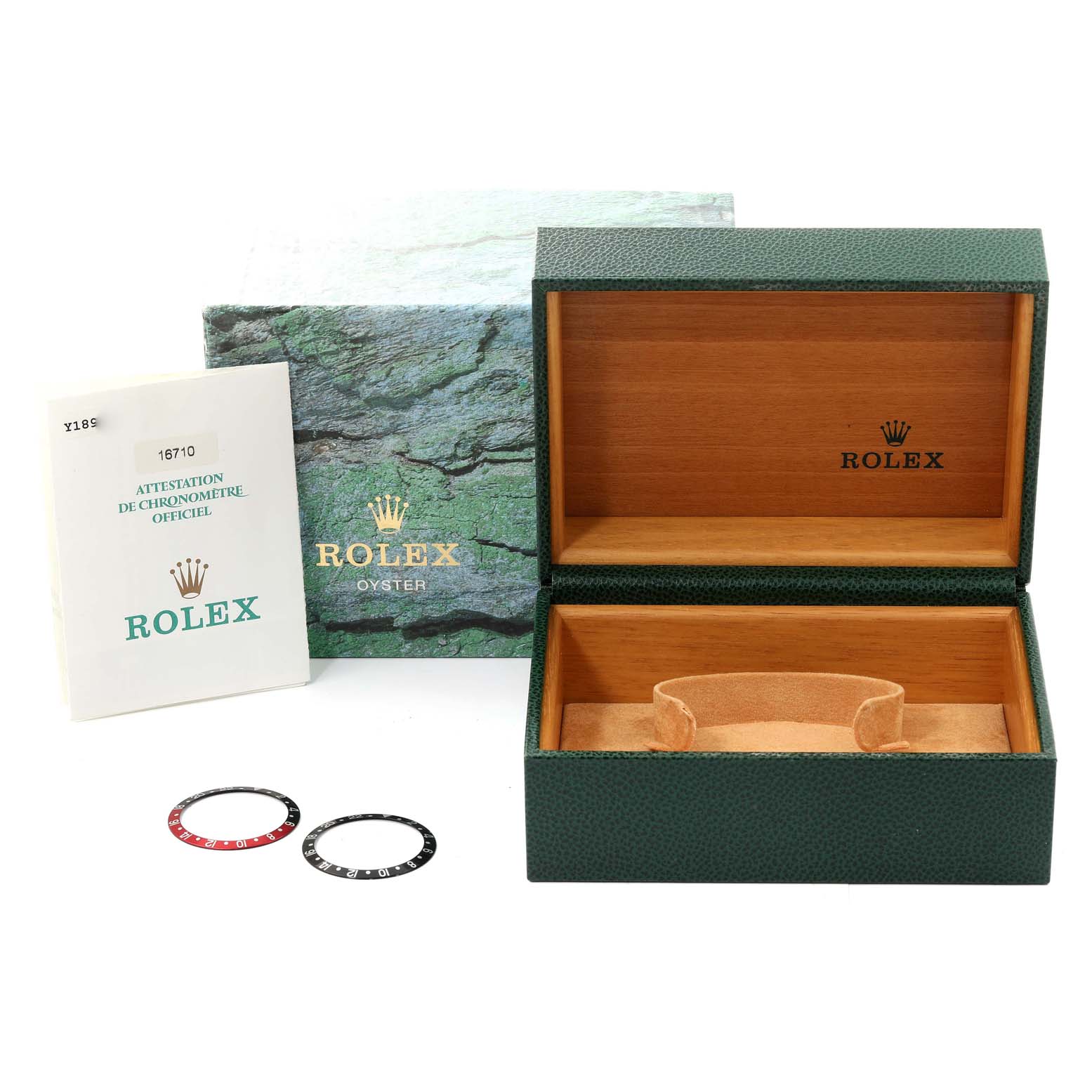 The image shows an open Rolex GMT-Master 16710 Men
s Stainless Steel Black Dial 16710 Men
s Stainless Steel Black Dial box with manuals and two bezels in front of the box.