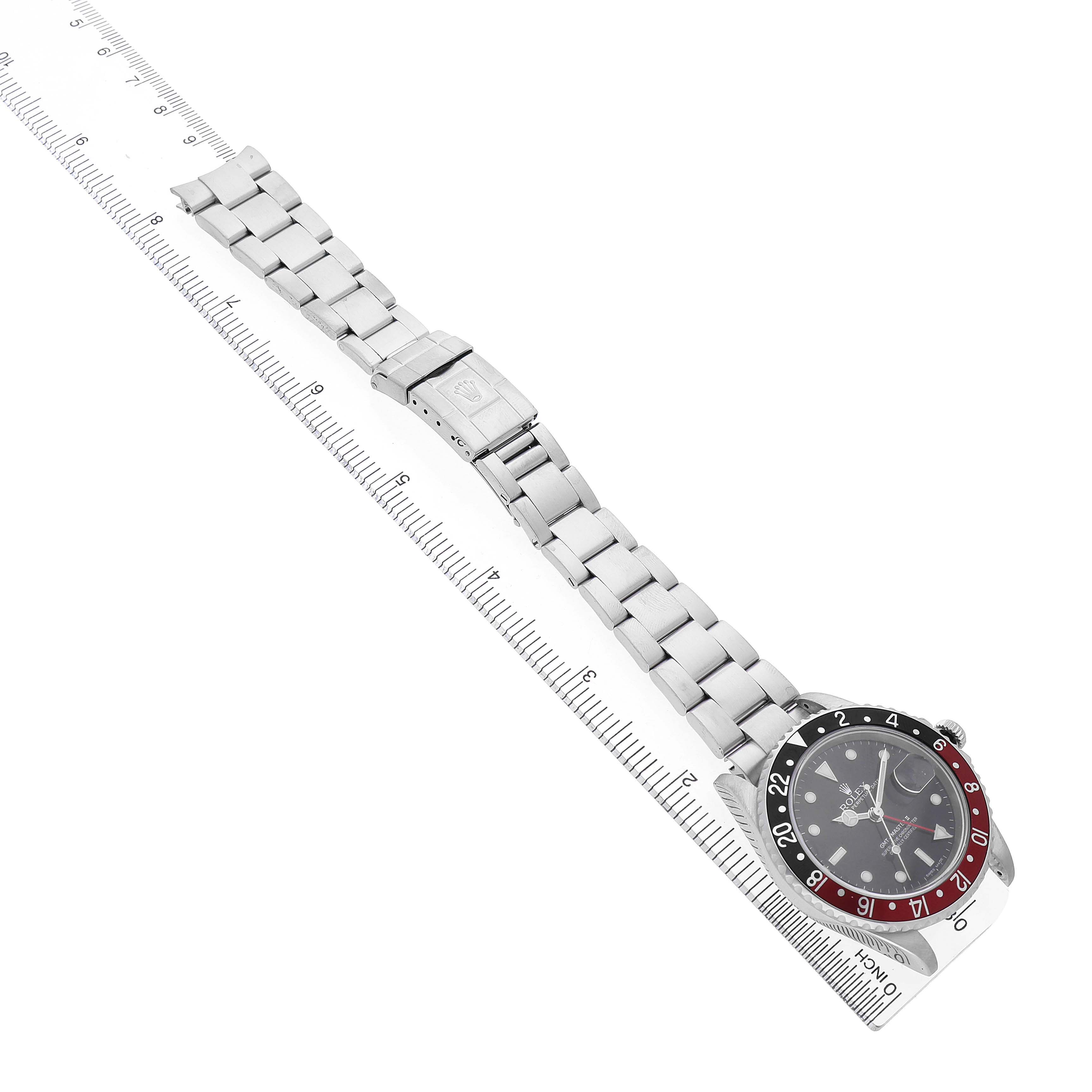 The Rolex GMT-Master 16710 Men's Stainless Steel Black Dial watch is shown diagonally from an overhead angle, featuring the bezel, dial, and entire bracelet.