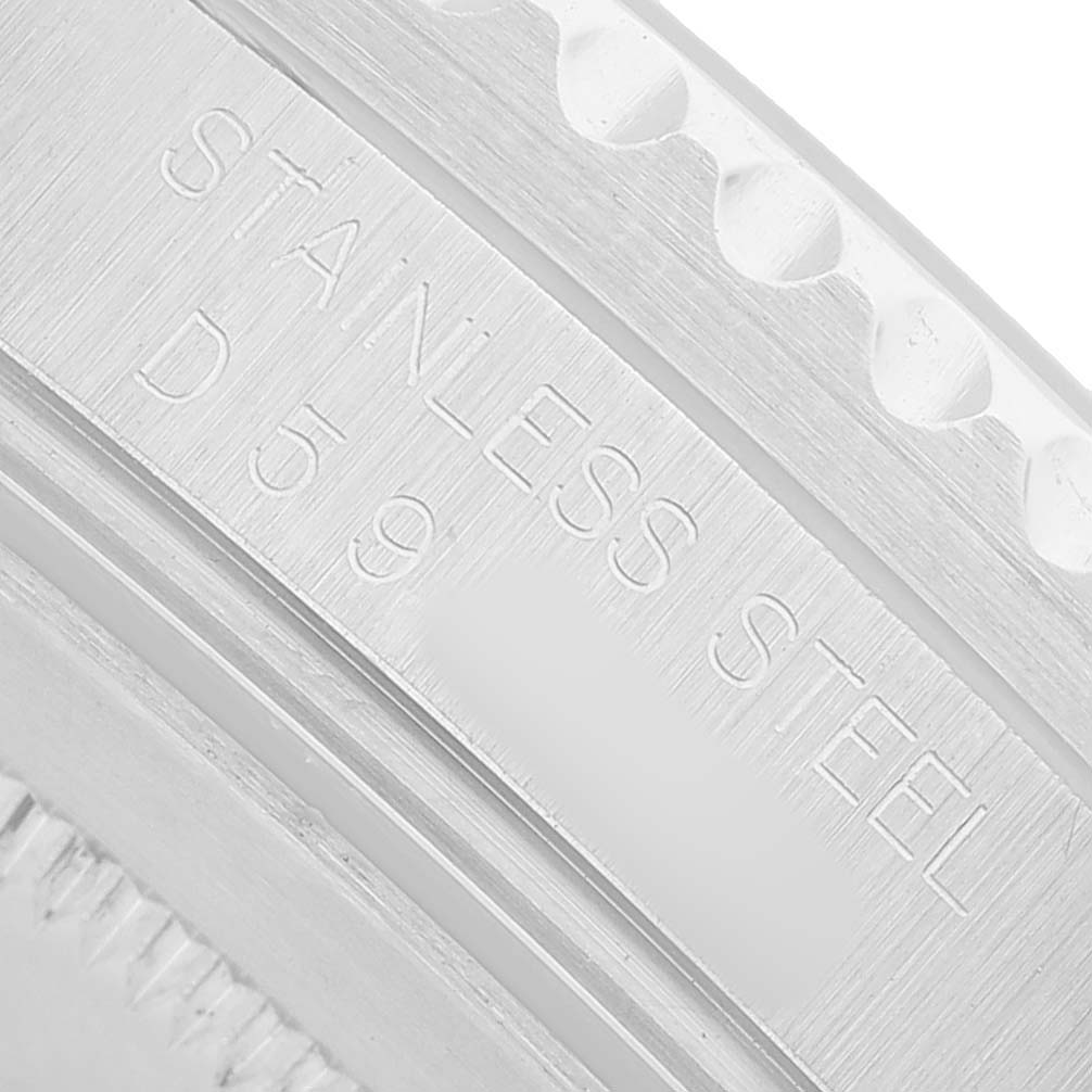 The image shows a close-up of the stainless steel engraving on the bezel edge of the Rolex GMT-Master 16710 Men's Stainless Steel Black Dial.