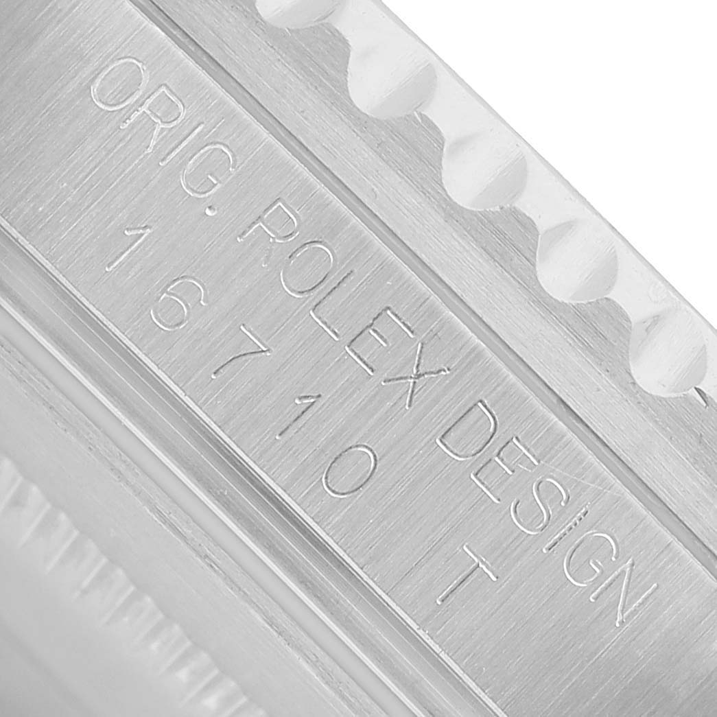 The image shows a close-up of the engraved side of the Rolex GMT-Master 16710 Men's Stainless Steel Black Dial model, displaying the design and model number.