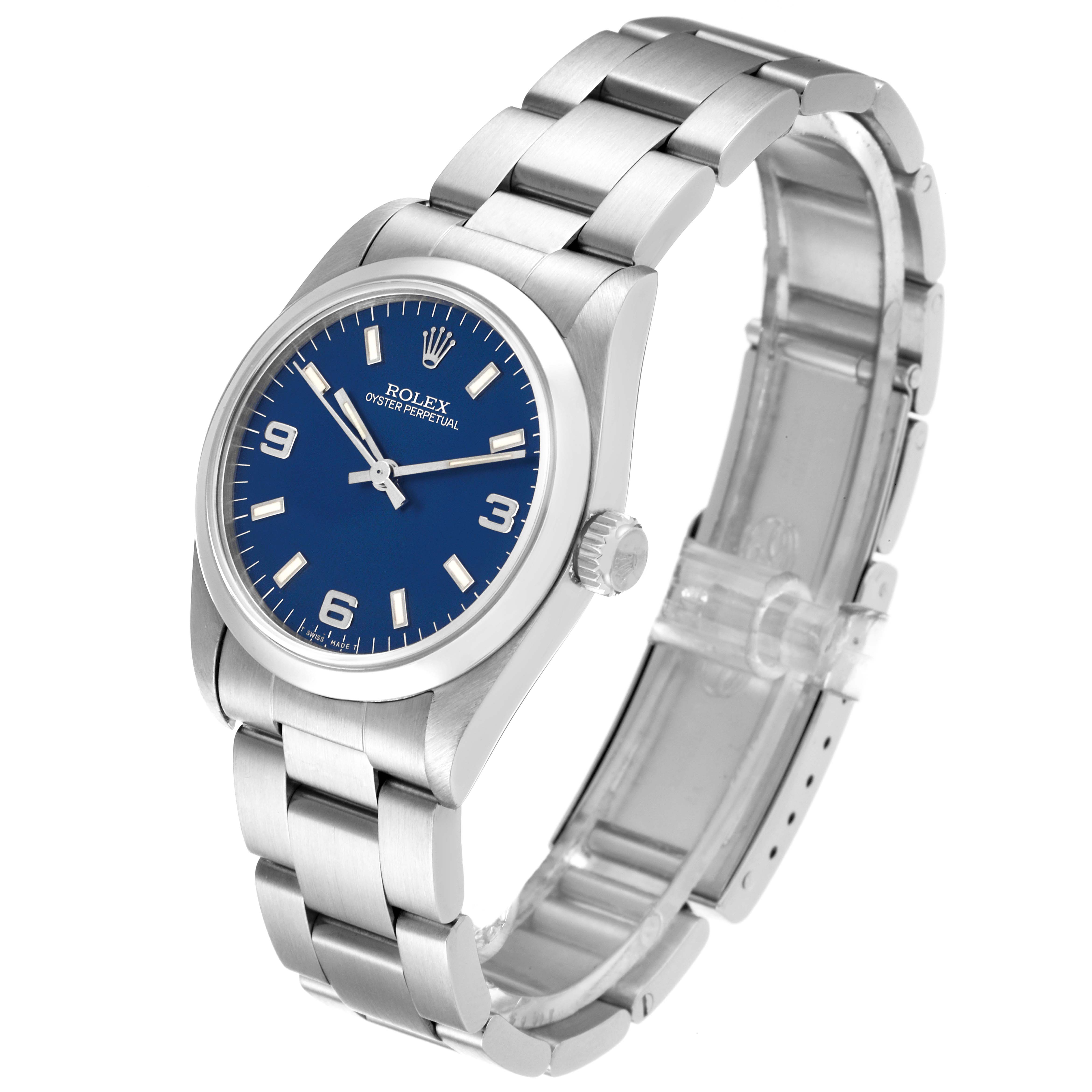 The image shows a side angle view of a Mid-Size Rolex Oyster Perpetual watch with a blue dial and a stainless steel bracelet.