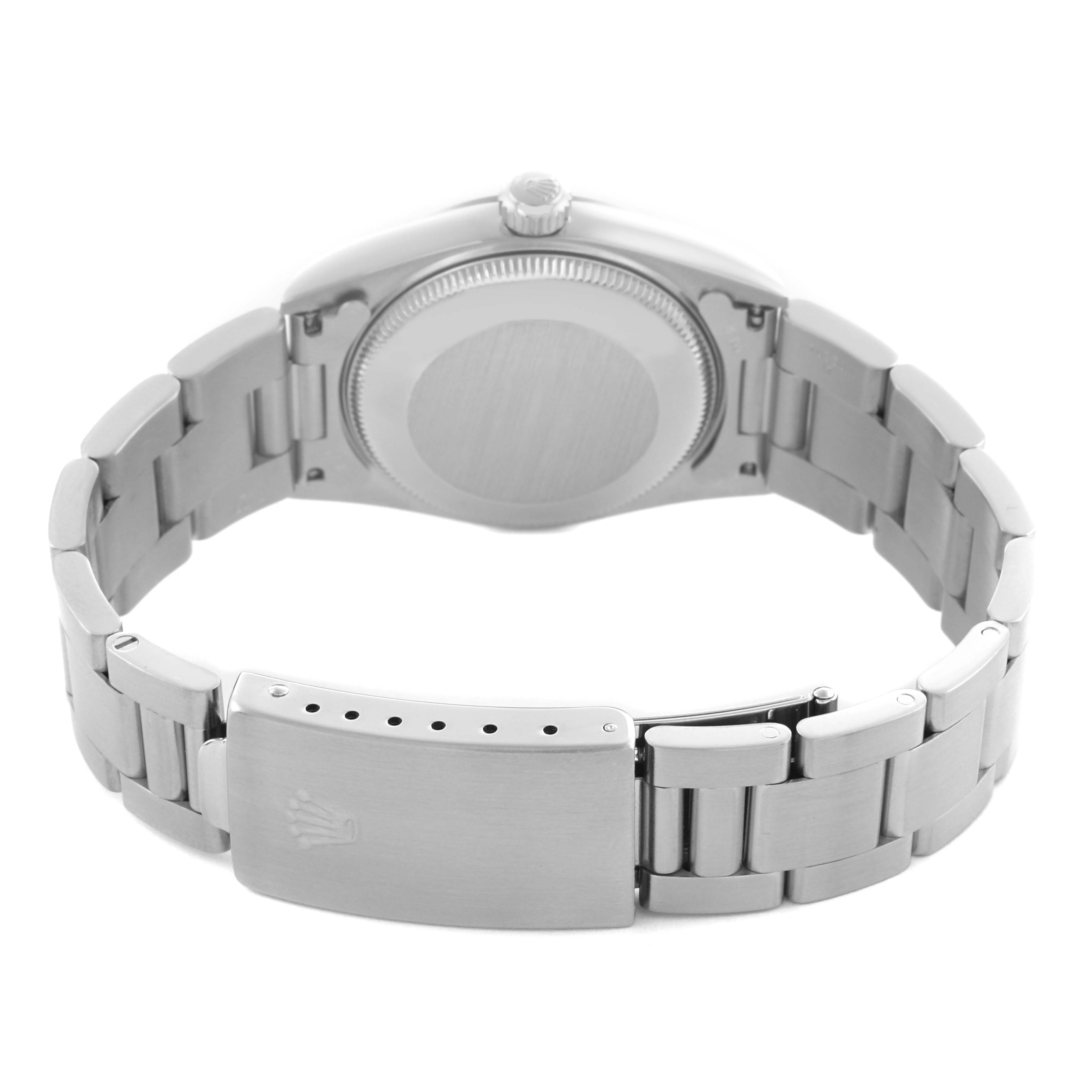 The image shows the back view of a Rolex Oyster Perpetual, highlighting the case back, bracelet, and the clasp with the Rolex logo.