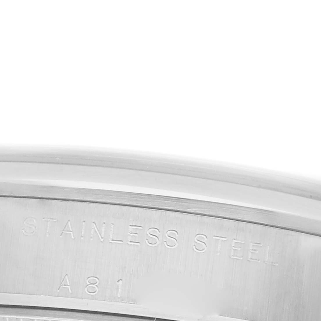 The image shows a close-up of the stainless steel case back of a Rolex Oyster Perpetual watch.
