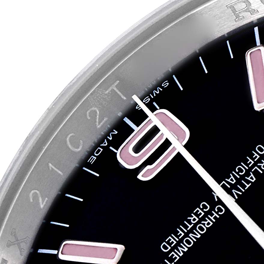 The image shows a close-up of the dial and bezel of a Rolex Oyster Perpetual 116000 Men's Stainless Steel Black Dial 116000 Men's Stainless Steel Black Dial, highlighting part of the indices and text.