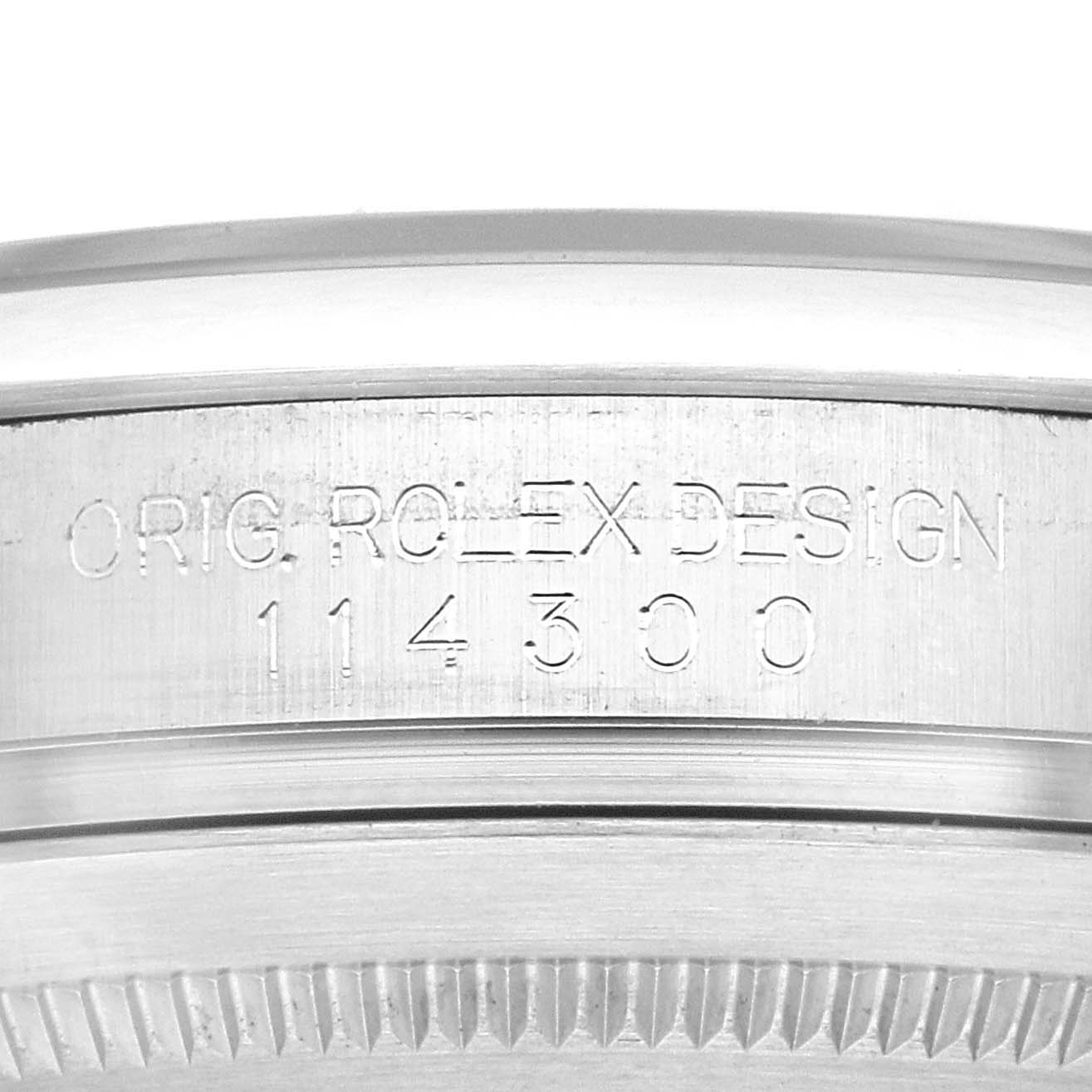 This image shows a close-up of the case side of the Rolex Oyster Perpetual 114300 Men
s Stainless Steel Black Dial 114300 Men
s Stainless Steel Black Dial, displaying the model number engraving.