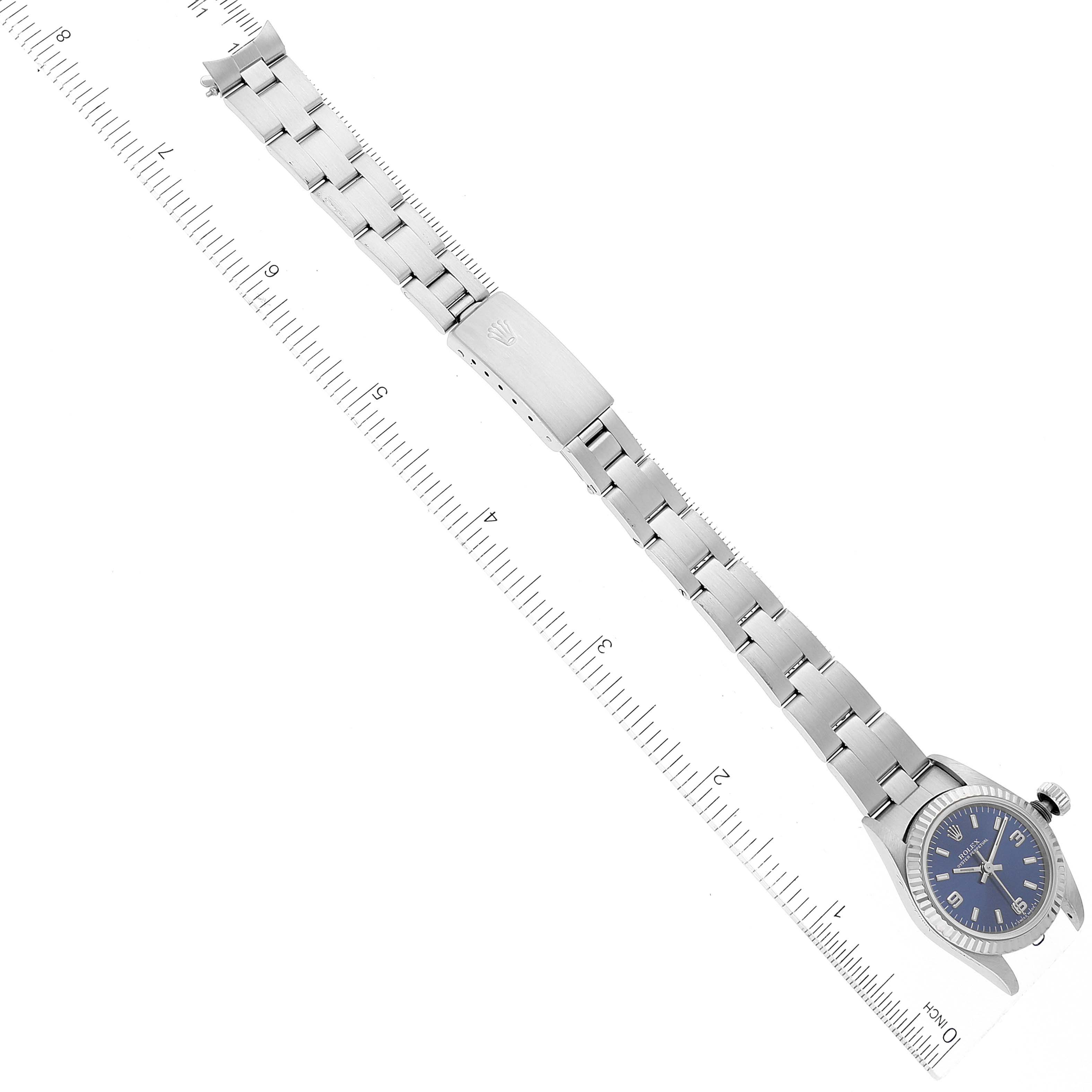 The image shows the Rolex Oyster Perpetual 67194 Women's Stainless Steel Blue Dial 67194 Women's Stainless Steel Blue Dial watch at a top-down angle, displaying the full bracelet and watch face.