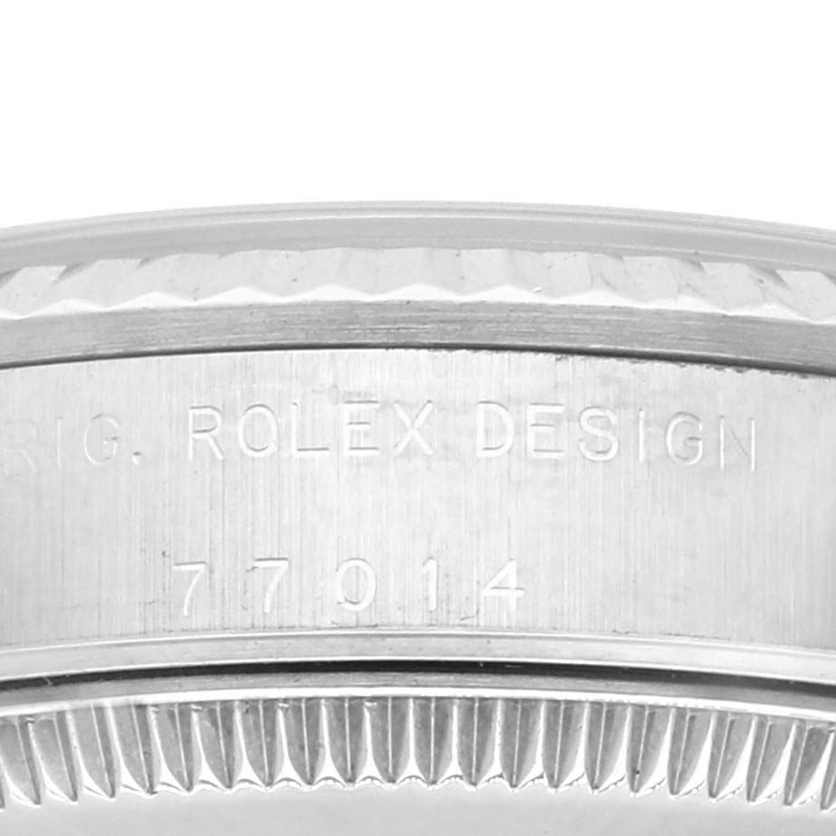 This image shows a close-up of the engraved side of a Mid-Size Rolex watch case featuring the model number and "ROLEX DESIGN."