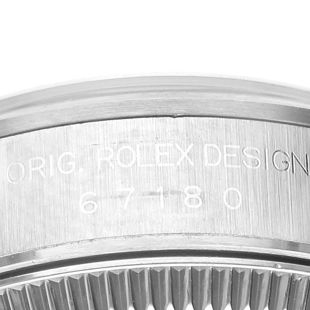 The image shows a close-up of the side with engravings on the bezel of a Rolex Oyster Perpetual 67180 Women's Stainless Steel Pink Dial 67180 Women's Stainless Steel Pink Dial watch.