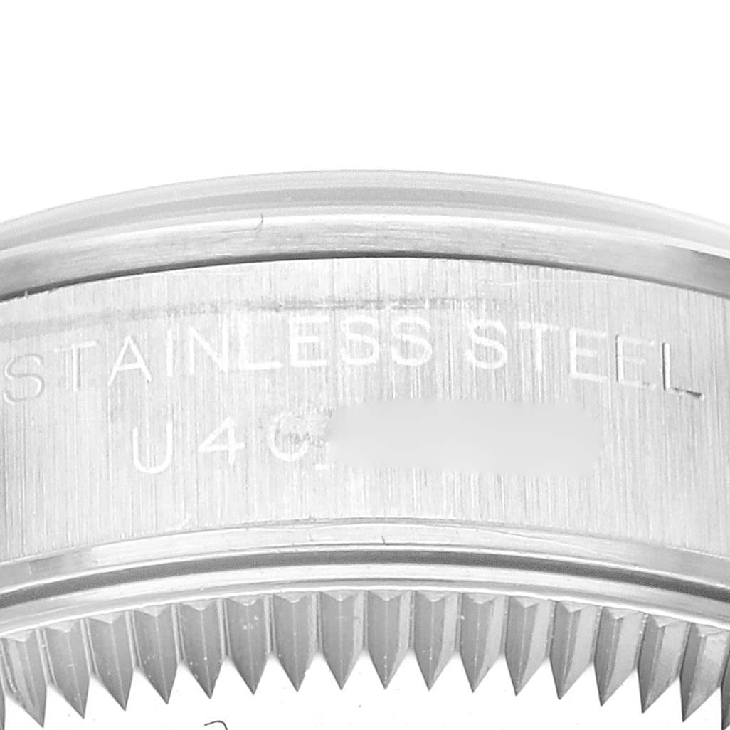 This image shows a close-up of the stainless steel casing of a Rolex Oyster Perpetual 67180 Women's Stainless Steel Black Dial 67180 Women's Stainless Steel Black Dial watch.