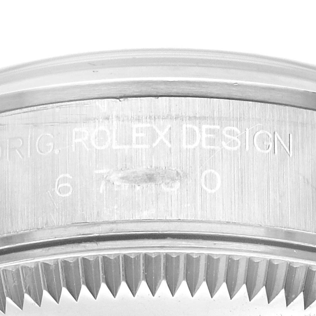 The image shows a close-up angle of the case side of a Rolex Oyster Perpetual 67180 Women's Stainless Steel Black Dial 67180 Women's Stainless Steel Black Dial, highlighting the "ROLEX DESIGN" engraving.