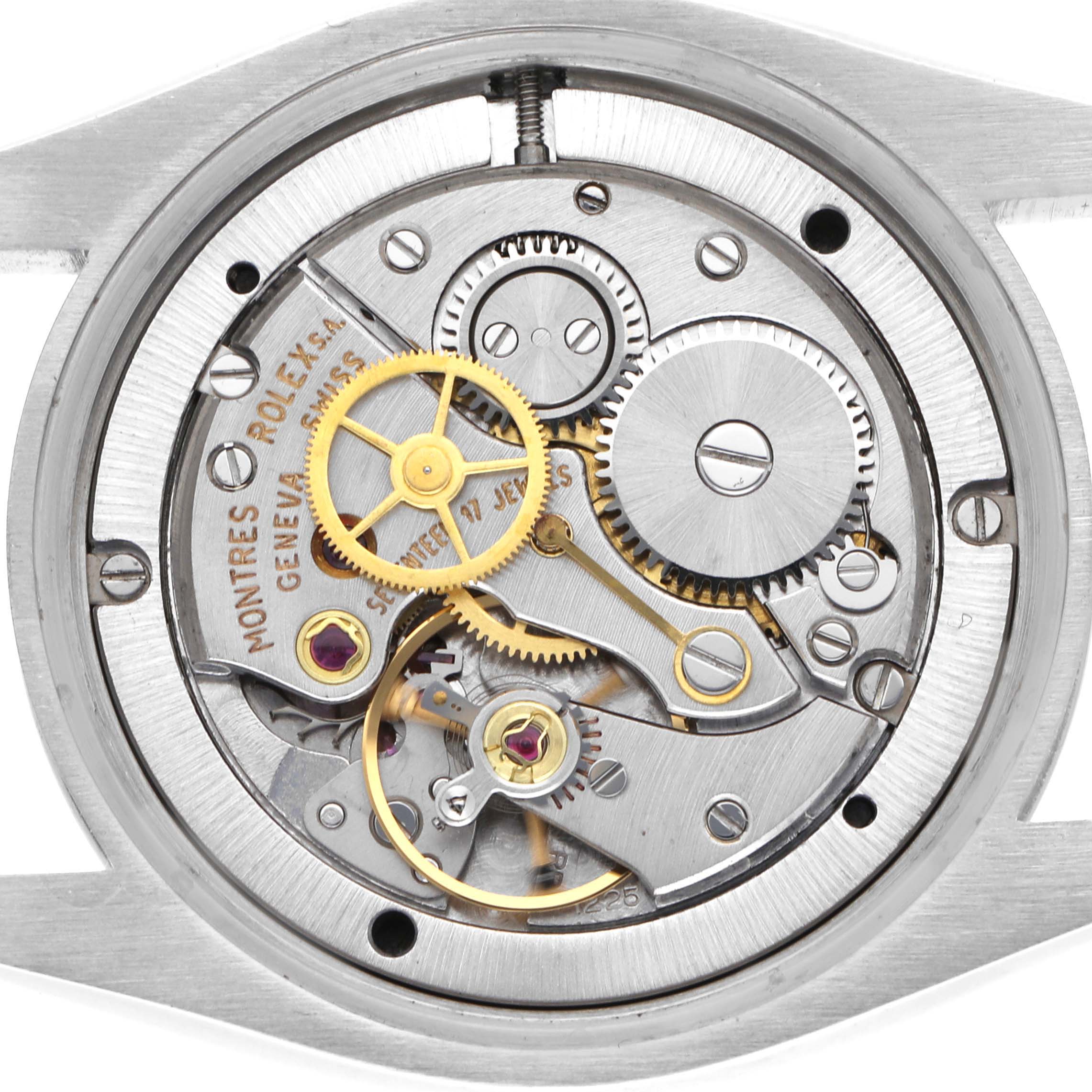 The image shows the back view of a Rolex Date 6694 Men's Stainless Steel Black Dial 6694 Men's Stainless Steel Black Dial model, revealing its intricate movement and gears.