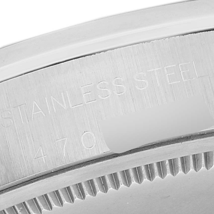 This is an angled close-up shot of the stainless steel back of a Vintage Collection Rolex watch.