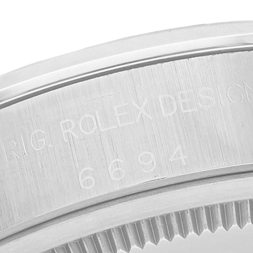 This close-up image shows the engraved side and part of the patterned edge of the bezel of the Rolex Vintage Collection 6694 Men
s Stainless Steel Silver Dial 6694 Men
s Stainless Steel Silver Dial model.